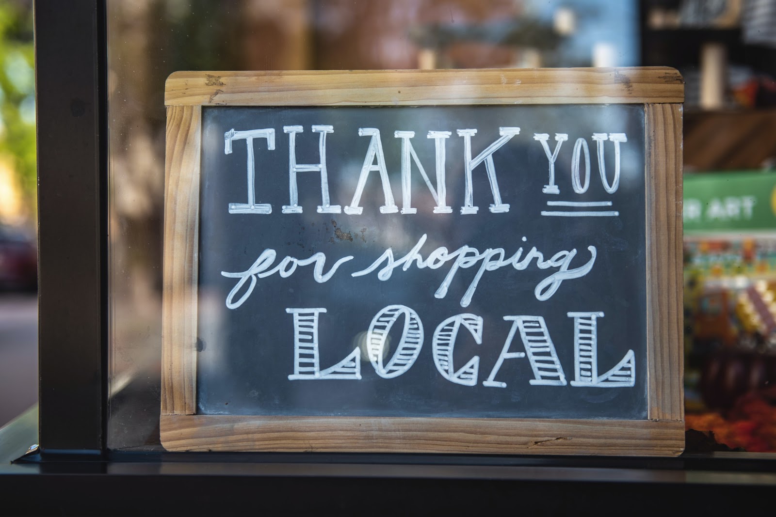 a sign saying "thank you for shopping local"