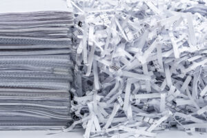 a pile of documentation next to the shredded papers 