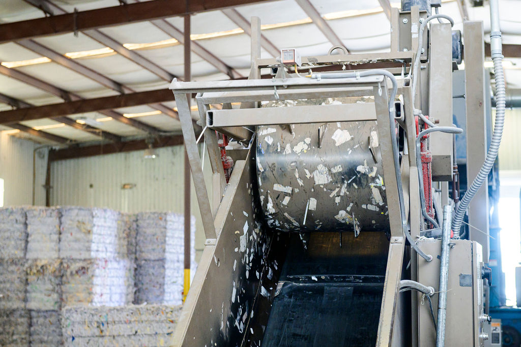 Commercial shredding machine processing confidential documents during secure paper shredding and document destruction services.